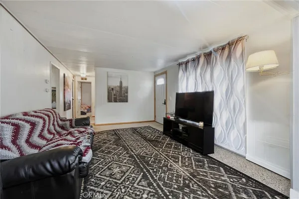 a view of a livingroom with furniture and a hallway