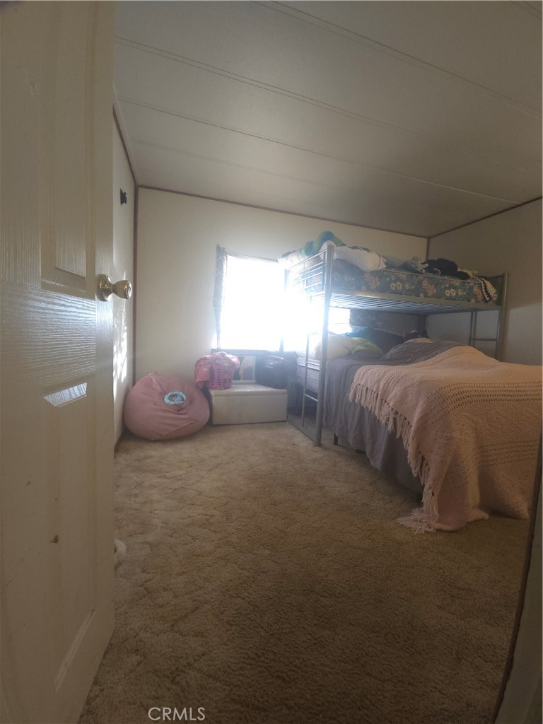 3114 Manzanita Road Nice, CA 95464 - Photo 3 of 10 a spacious bedroom with a bed and a window