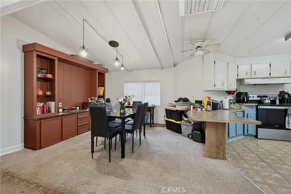 a kitchen with kitchen island granite countertop a sink cabinets and window