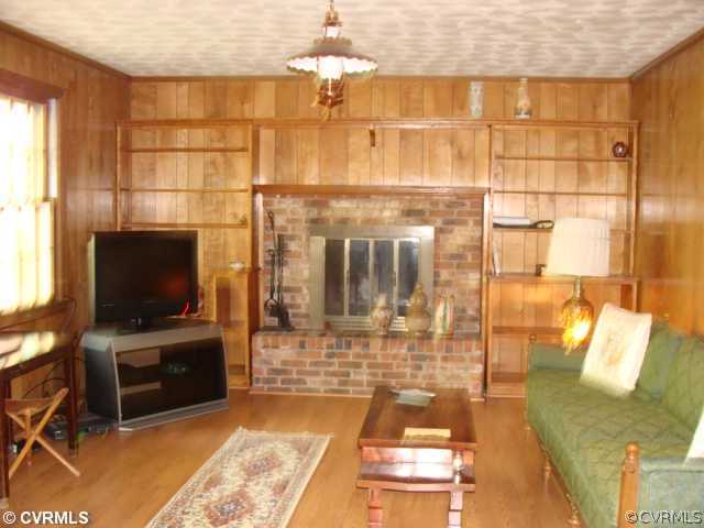 1323 Covington Road Colonial Heights, VA 23834 - Photo 5 of 12 a living room with a flat screen tv and floor to ceiling window