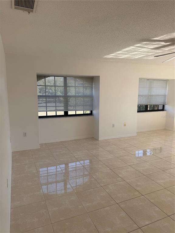23465 Harbor View Road, Unit 201 Punta Gorda, FL 33980 - Photo 13 of 50 a view of empty room with windows