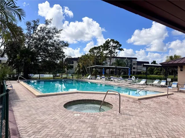 a view of a swimming pool with a lounge chairs