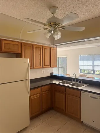 a kitchen with a sink and refrigerator