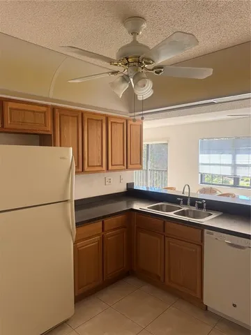 a kitchen with a sink and refrigerator