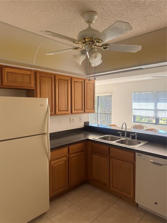 23465 Harbor View Road, Unit 201 Punta Gorda, FL 33980 - Photo 8 of 50 a kitchen with a sink and refrigerator