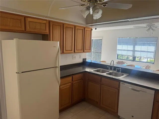 a kitchen with a sink and refrigerator