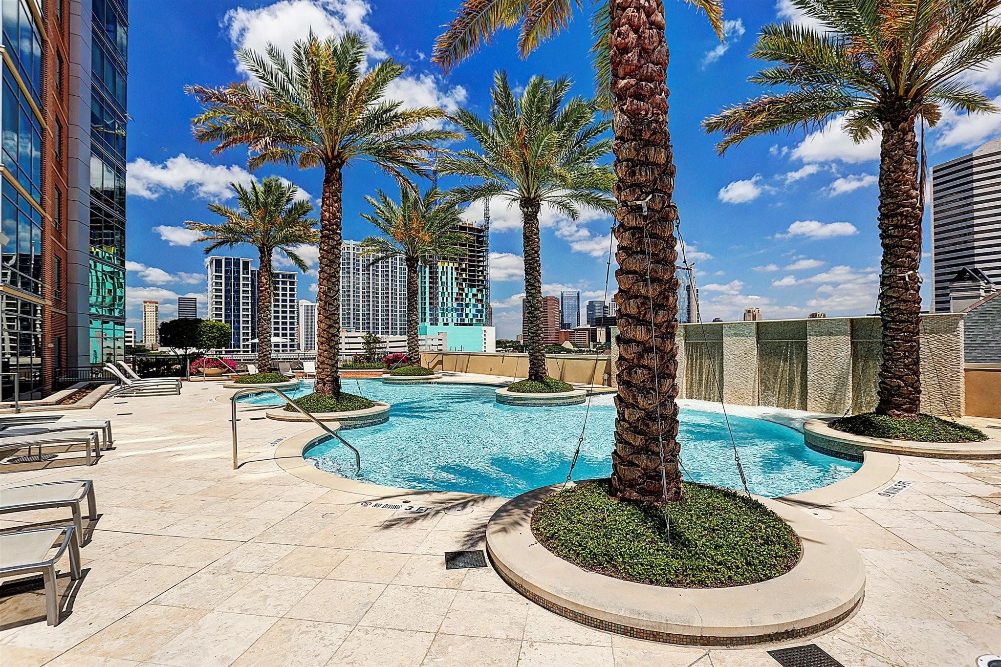 2207 Bancroft Lane, Unit 604 Houston, TX 77027 - Photo 27 of 40 a view of a swimming pool with a table and chairs