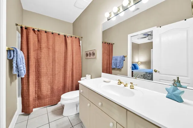 a bathroom with a double vanity sink mirror and toilet