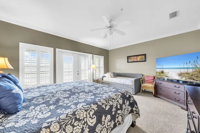 a spacious bedroom with a large bed and a chandelier