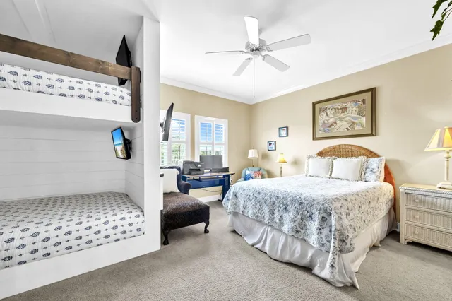 a bedroom with a bed and ceiling fan