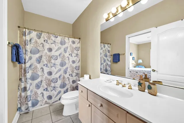 a bathroom with a double vanity sink mirror and toilet