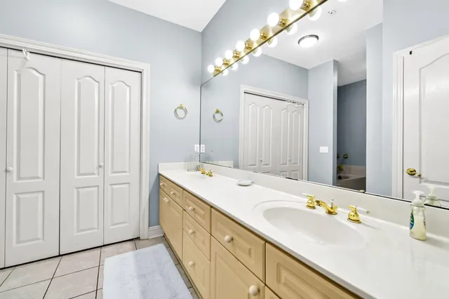 a bathroom with a double vanity sink and mirror