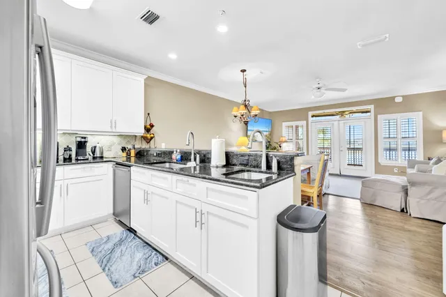 a kitchen with sink cabinets and living room view