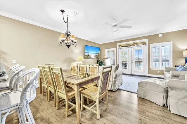 a view of a dining room with furniture wooden floor and chandelier