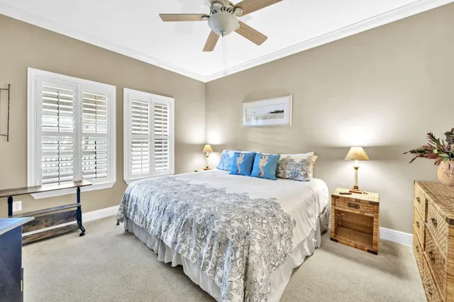 a spacious bedroom with a bed and a chandelier