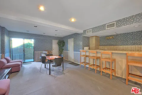 a living room with furniture and a dining table