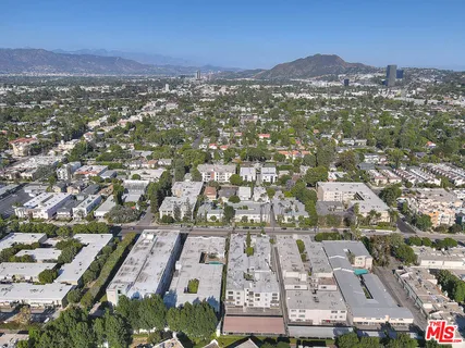 an aerial view of residential houses with city view