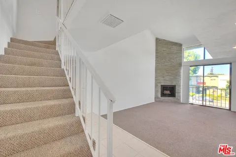 a view of an empty room with stairs
