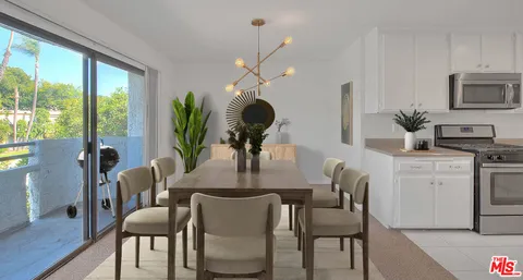 a dining room with furniture potted plants and wooden floor