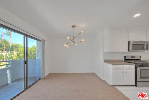 a view of a kitchen with a sink cabinets and a window