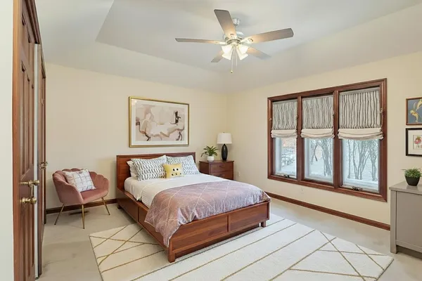 a bedroom with a large bed couch and a window