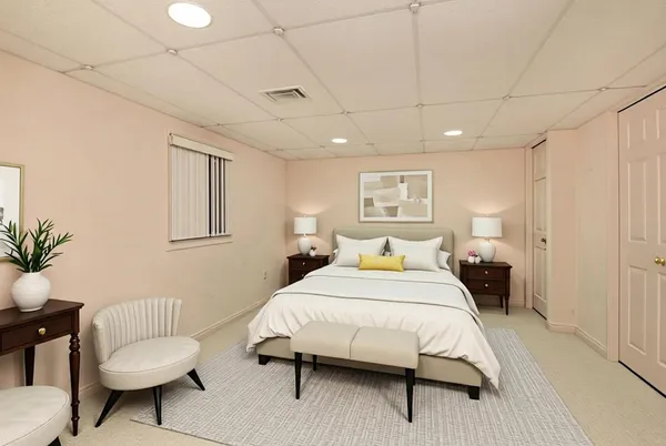 a bedroom with a bed and a couch