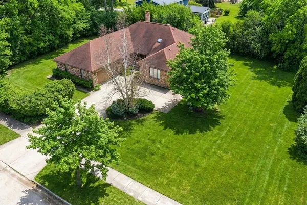 an aerial view of a house with garden space and street view