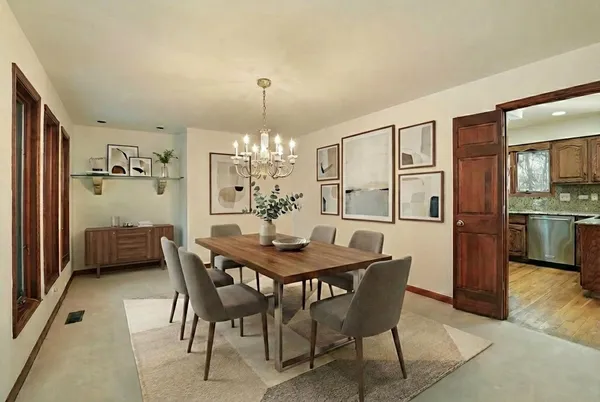 a view of a dining room with furniture and chandelier