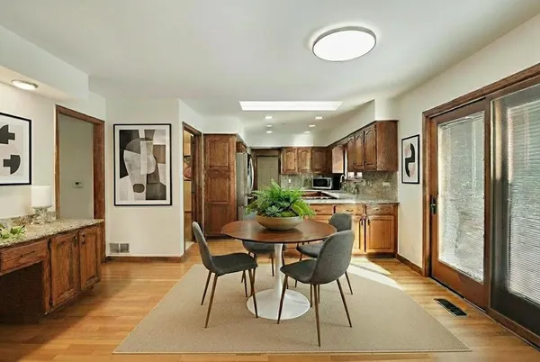 a kitchen with stainless steel appliances kitchen island granite countertop a refrigerator and a stove top oven