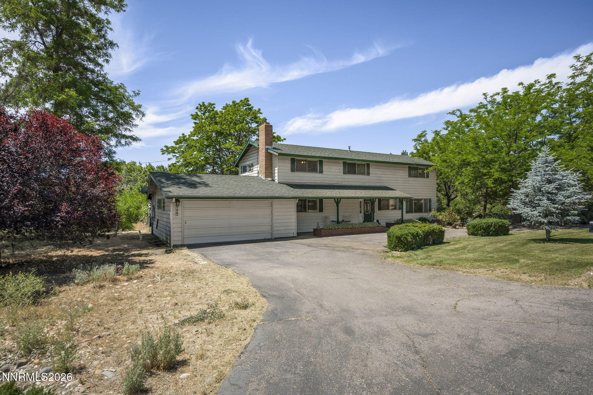 549 Ruby Lane Carson City, NV 89706 - Photo 2 of 37 a front view of a house with a yard and garage