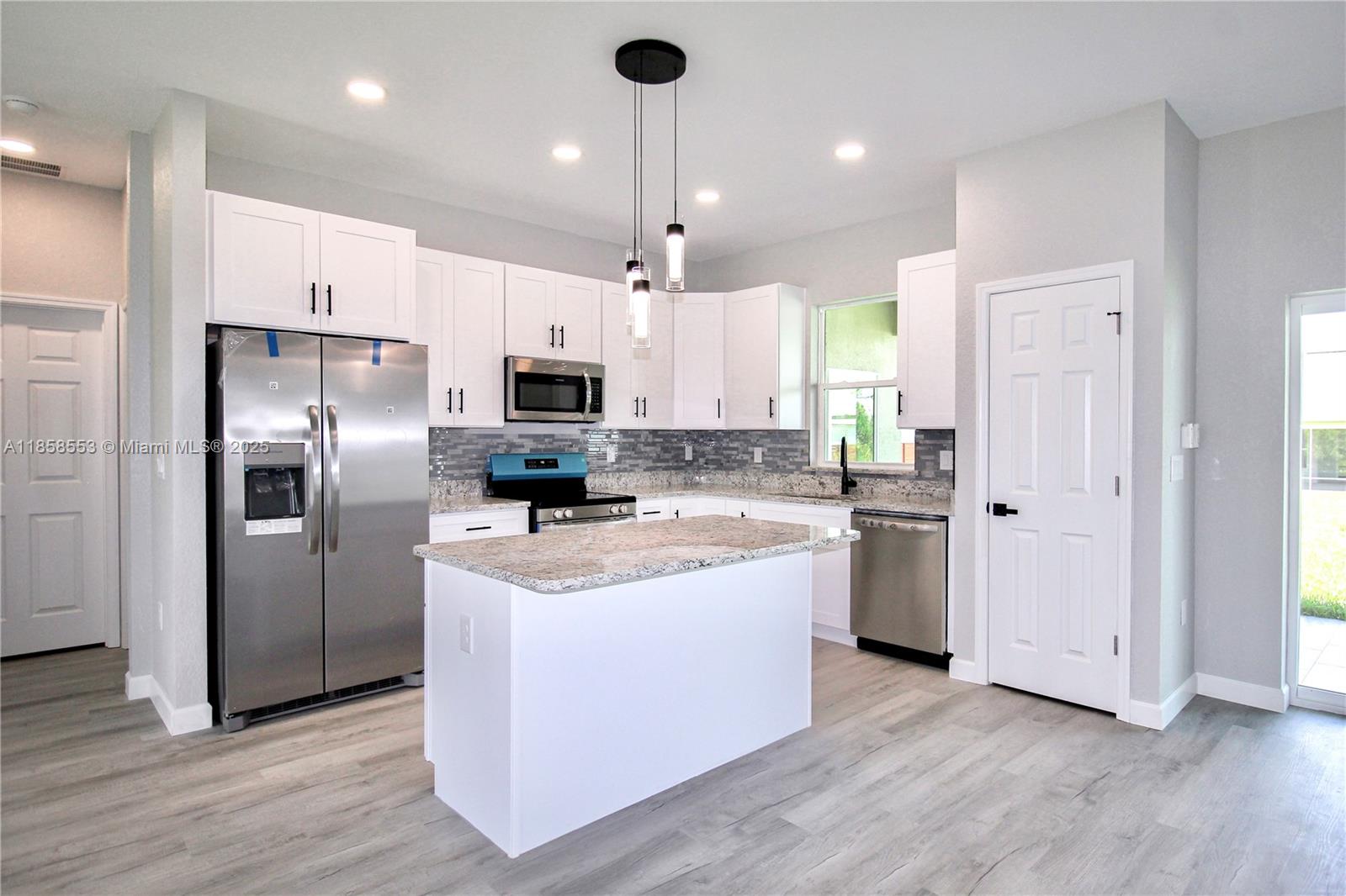 4631 Mignon Drive Sebring, FL 33872 - Photo 2 of 40 a kitchen with stainless steel appliances granite countertop a refrigerator a sink dishwasher a stove and a refrigerator
