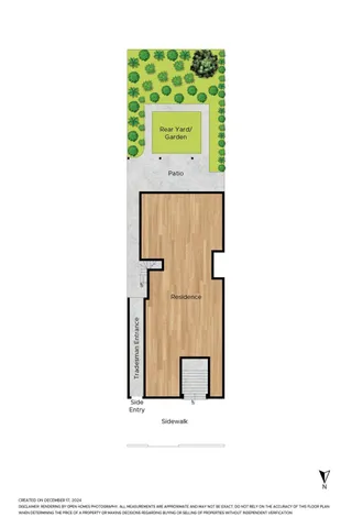 a view of a backyard with plants and palm tree