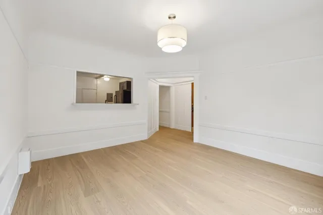 a view of an empty room and wooden floor