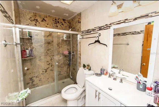 a bathroom with a sink toilet and shower