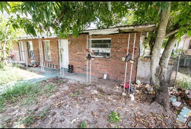 a backyard of a house with table and chairs