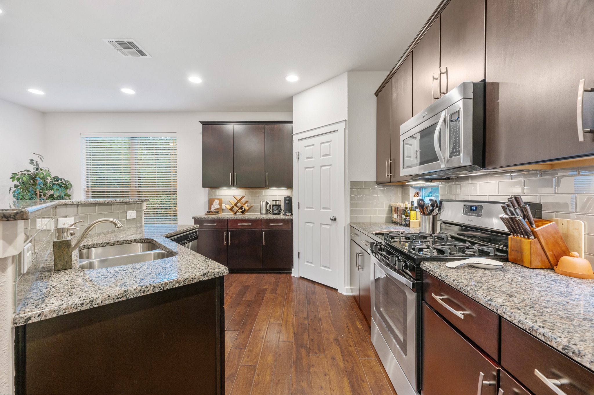 2101 Rivers Edge Way, Unit 19 Austin, TX 78741 - Photo 12 of 24 a kitchen with stainless steel appliances granite countertop a sink stove and refrigerator