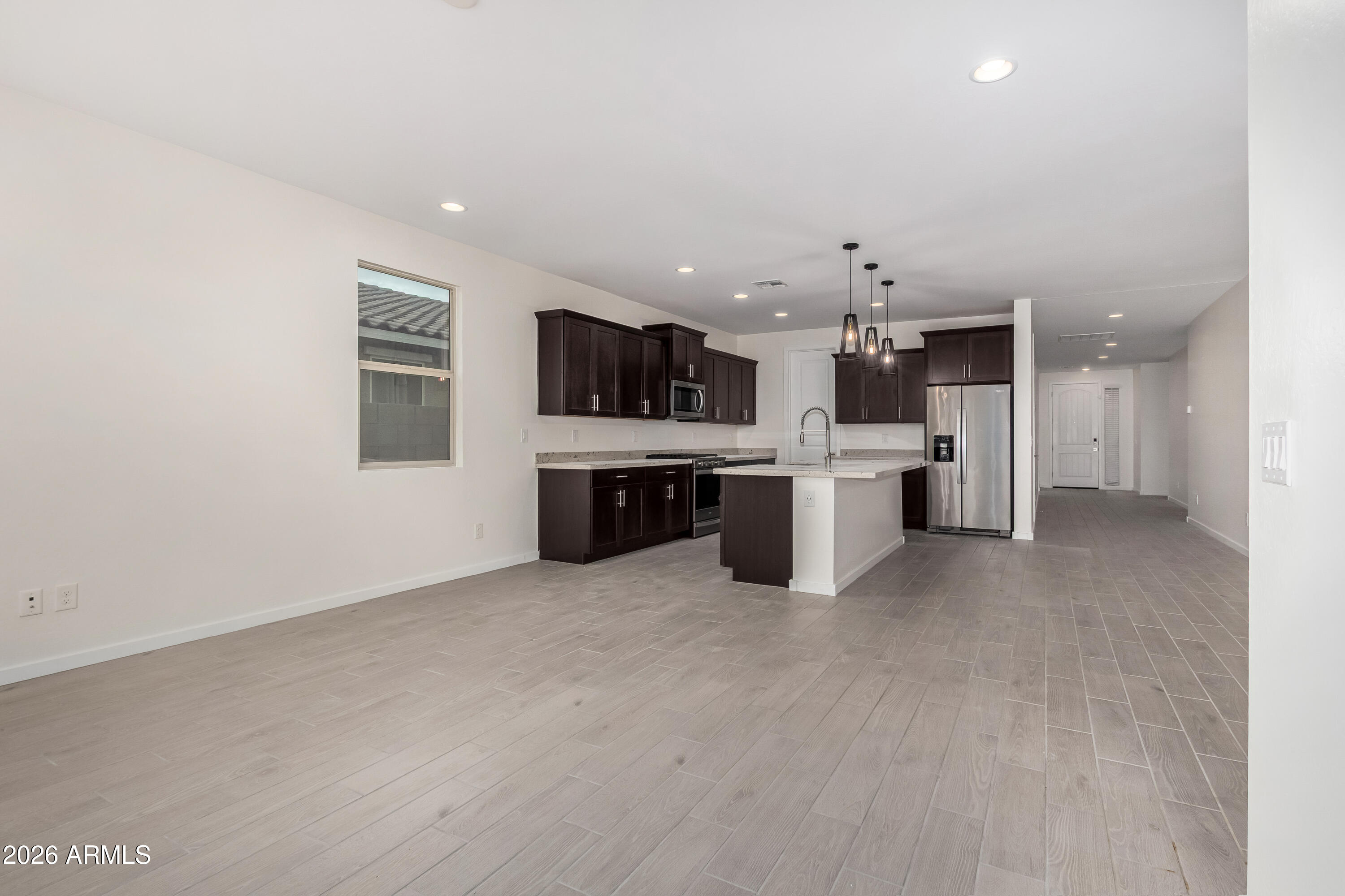 17352 West Red Fox Road Surprise, AZ 85387 - Photo 11 of 45 a view of a kitchen with a sink and a stove top oven