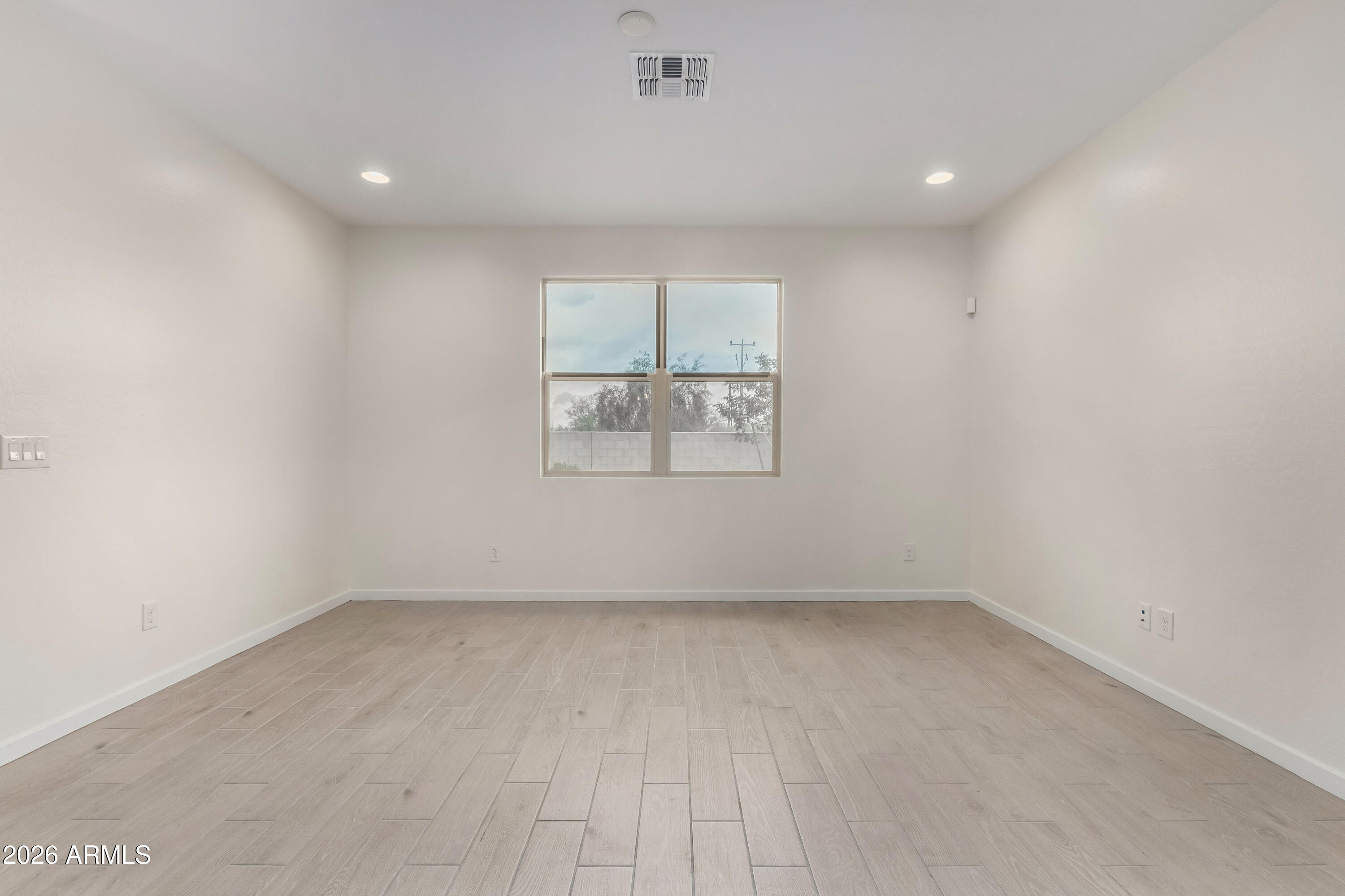 17352 West Red Fox Road Surprise, AZ 85387 - Photo 15 of 45 an empty room with a empty space and windows