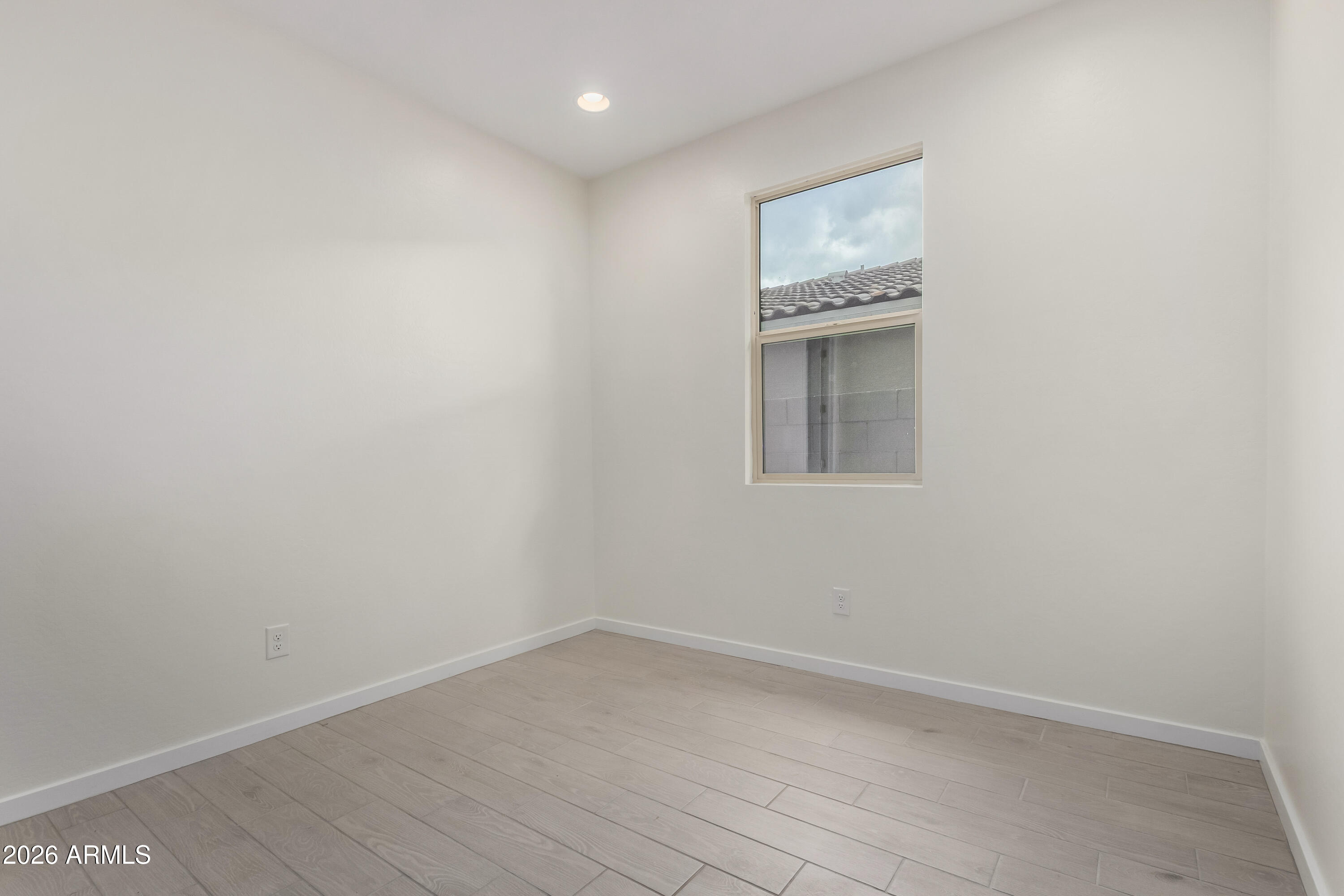 17352 West Red Fox Road Surprise, AZ 85387 - Photo 22 of 45 an empty room with a window