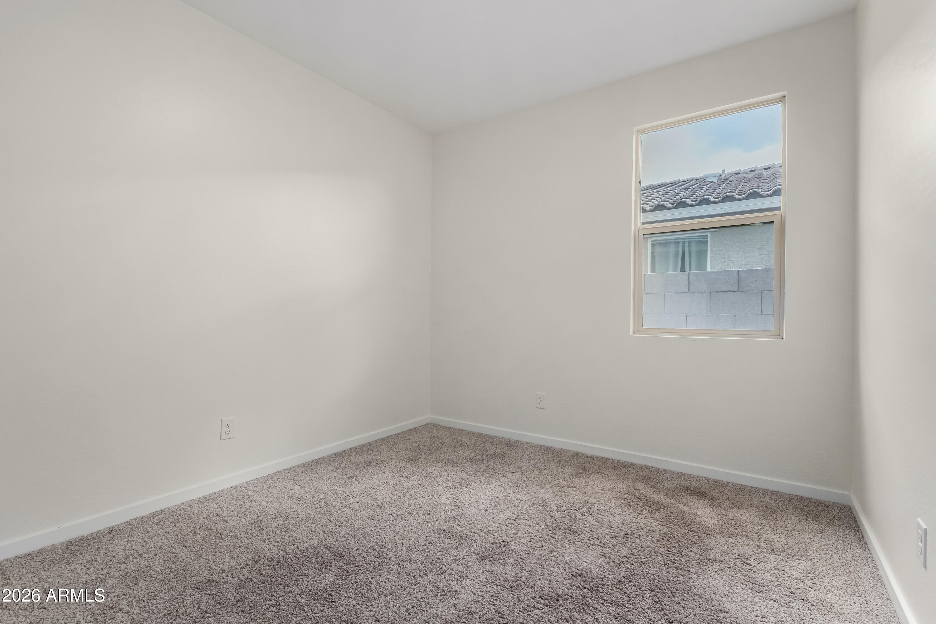 17352 West Red Fox Road Surprise, AZ 85387 - Photo 23 of 45 an empty room with a window