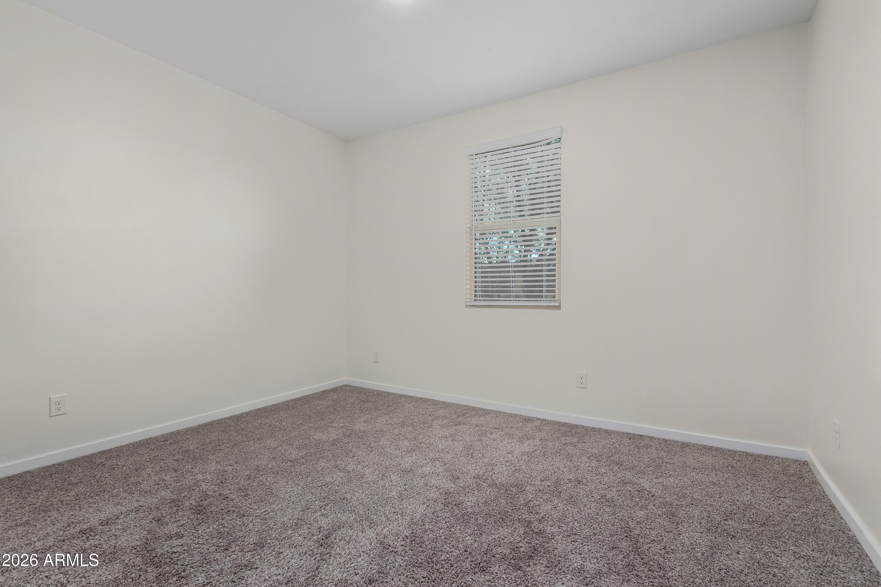 17352 West Red Fox Road Surprise, AZ 85387 - Photo 24 of 45 an empty room with a window