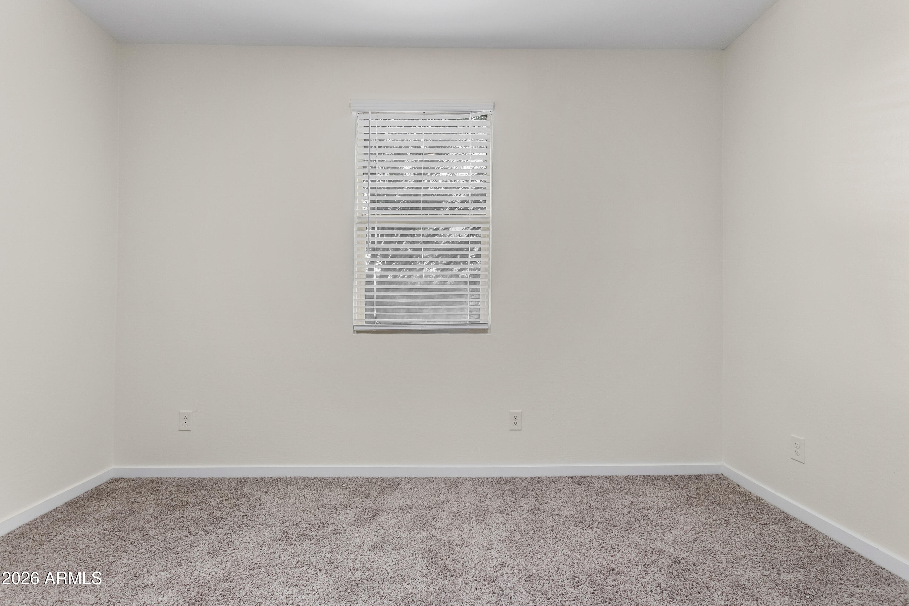 17352 West Red Fox Road Surprise, AZ 85387 - Photo 25 of 45 an empty room with a window