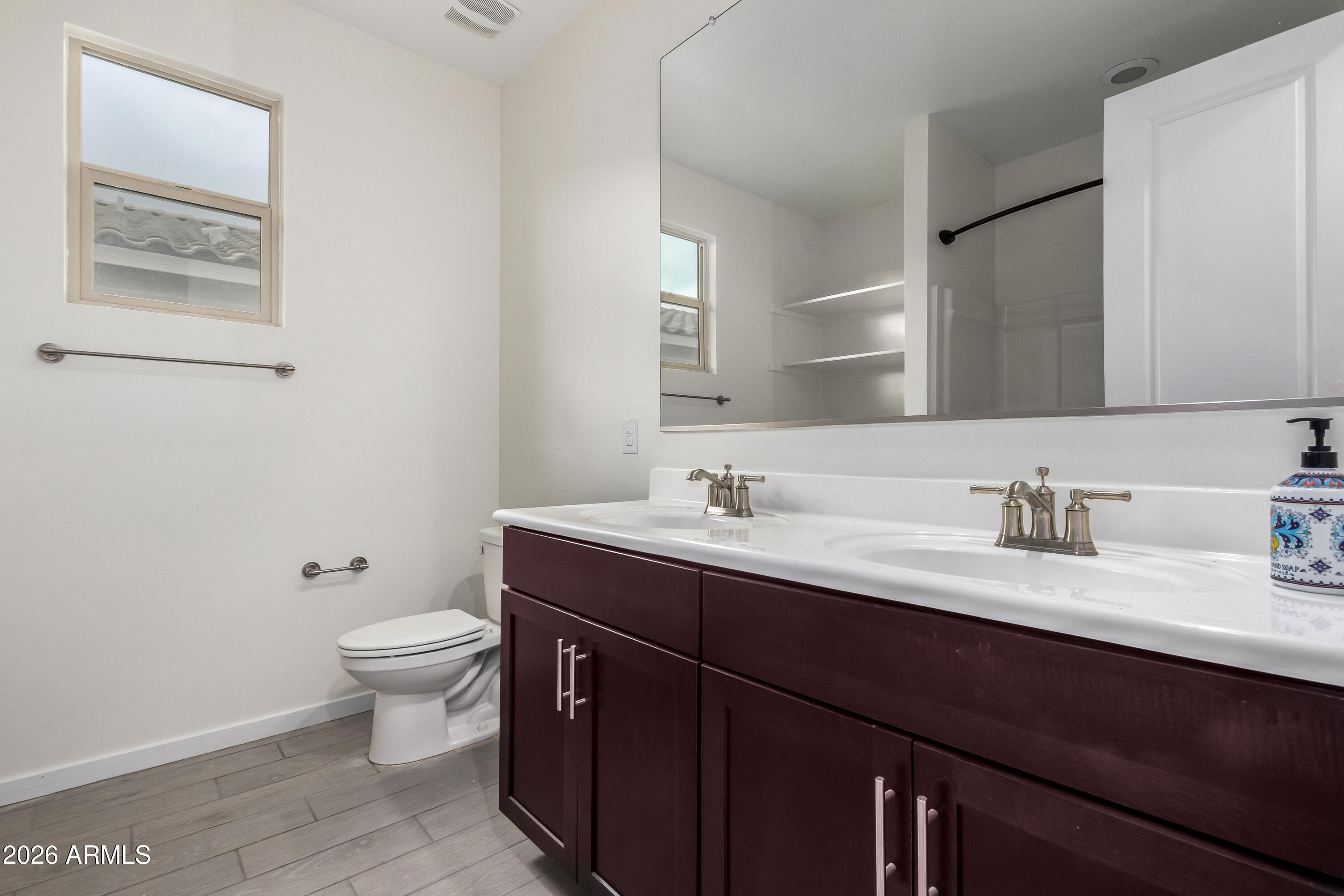 17352 West Red Fox Road Surprise, AZ 85387 - Photo 30 of 45 a bathroom with a granite countertop sink toilet and mirror