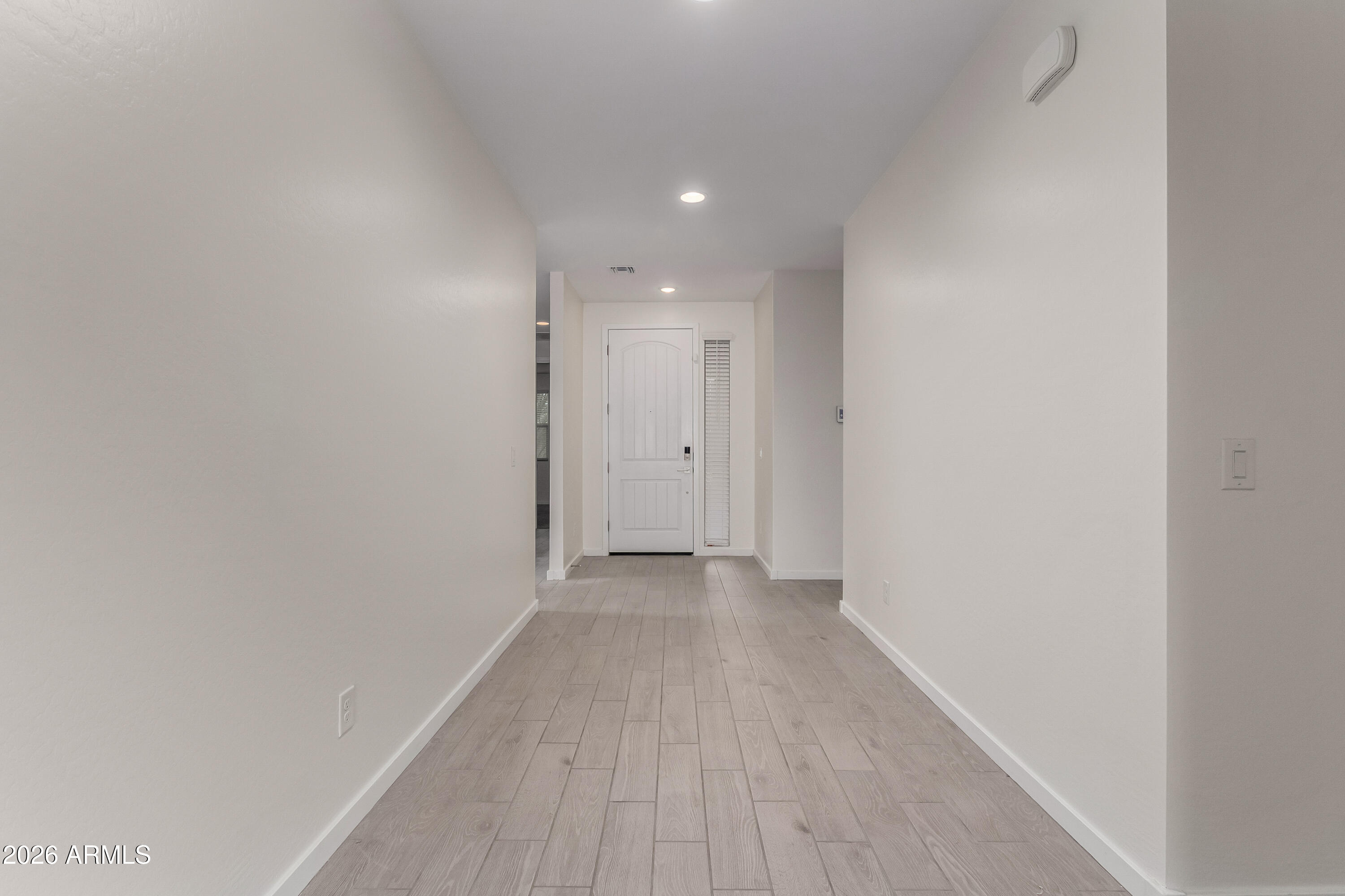 17352 West Red Fox Road Surprise, AZ 85387 - Photo 4 of 45 a view of a hallway with wooden floor