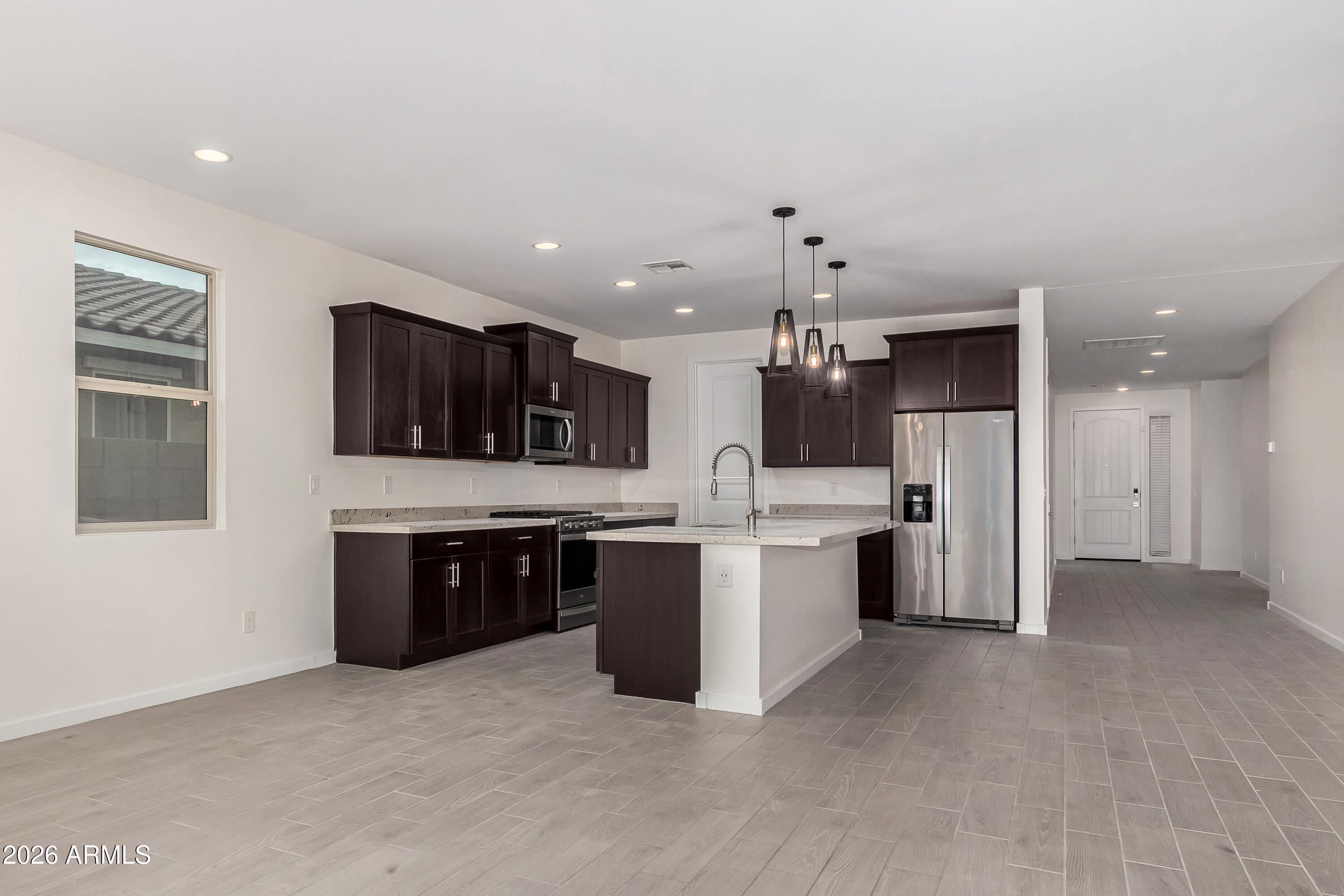 17352 West Red Fox Road Surprise, AZ 85387 - Photo 5 of 45 a large kitchen with a large counter top appliances and cabinets