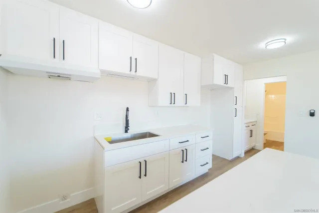 an empty room with a window and a ceiling fan