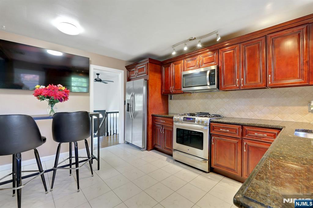 20 Blue Hill Road Norwood, NJ 07648 - Photo 15 of 49 a kitchen with stainless steel appliances granite countertop a refrigerator and a stove top oven