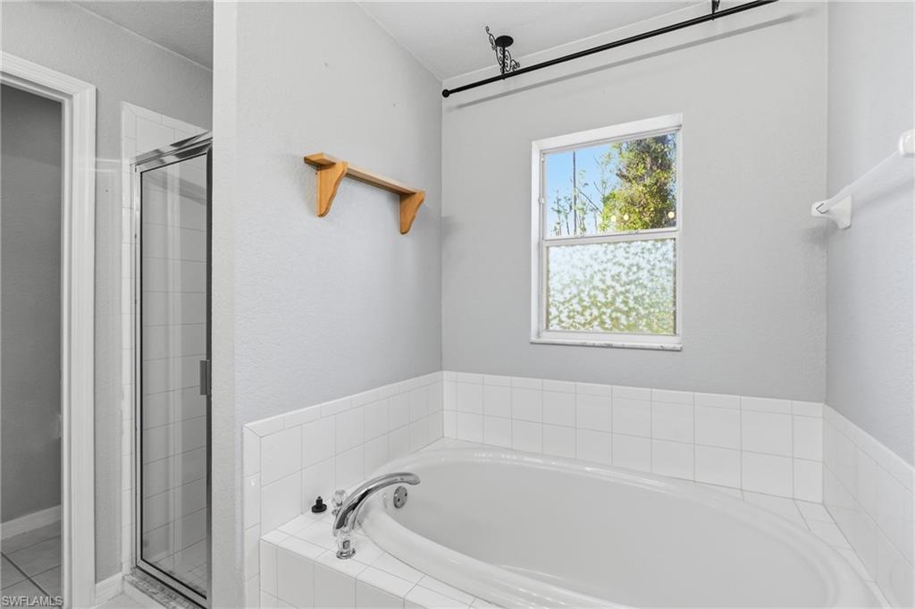 1562 Jakway Road North Port, FL 34288 - Photo 29 of 50 Full bathroom with a garden tub and a shower stall