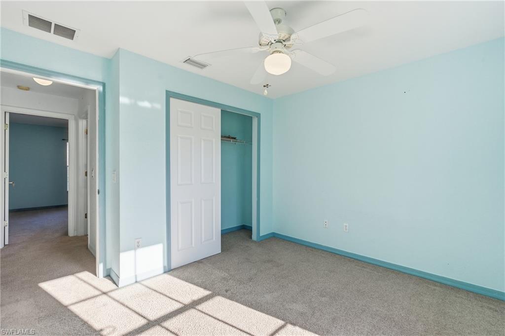 1562 Jakway Road North Port, FL 34288 - Photo 34 of 50 Unfurnished bedroom featuring carpet flooring, a closet, and a ceiling fan