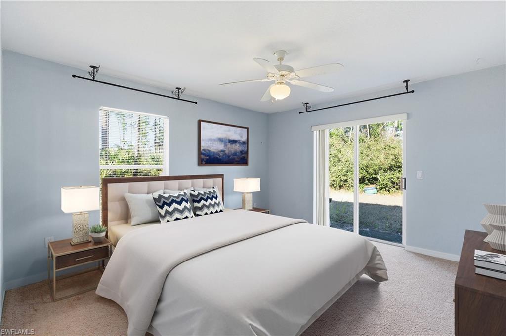 1562 Jakway Road North Port, FL 34288 - Photo 5 of 50 Bedroom featuring access to outside, light colored carpet, multiple windows, and a ceiling fan